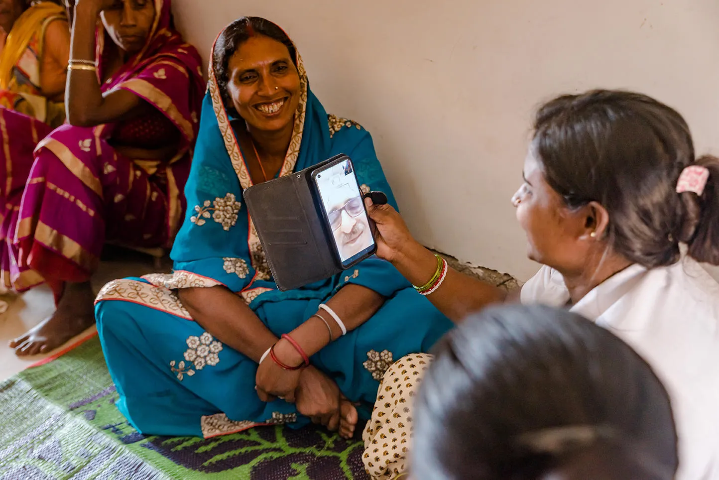 Women speaking to a doctor through a phone