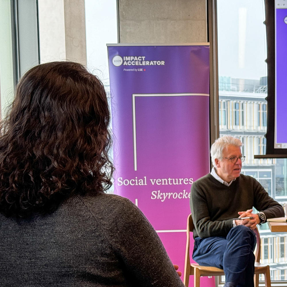 Man delivering a talk while seated